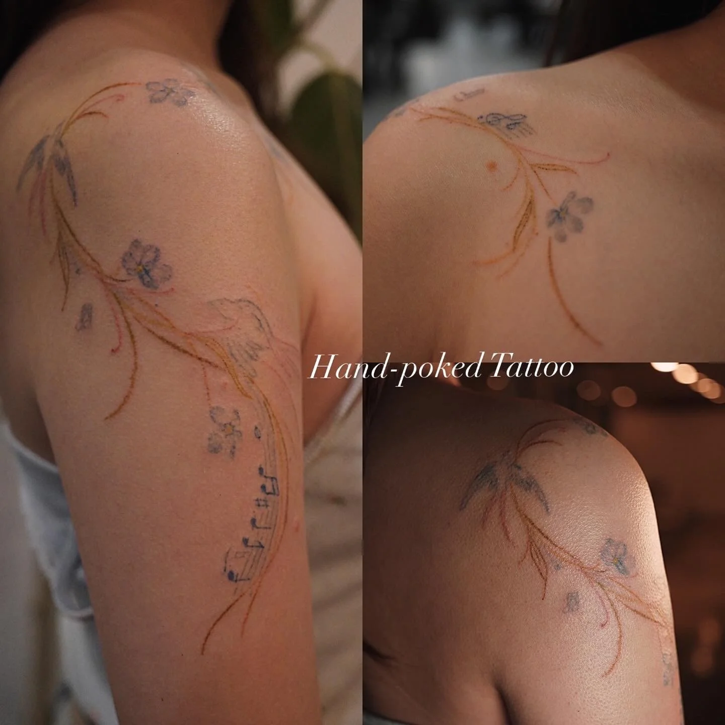 Close-up of a delicate, hand-poked tattoo of a slender branch with small blue flowers and orange leaves on a person's shoulder and upper arm.