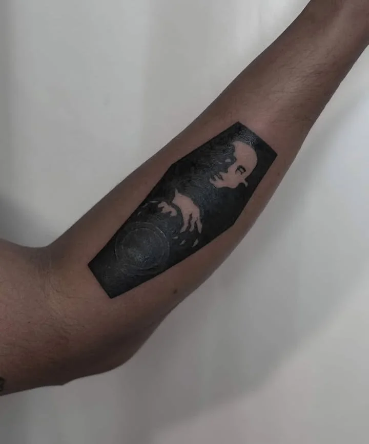A tattoo of a portrait of Michael Jackson on a person's forearm.