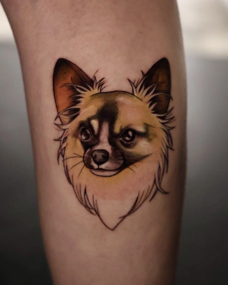 Tattoo of a dog's face, with a mix of realistic and sketchy elements, on a person's arm.