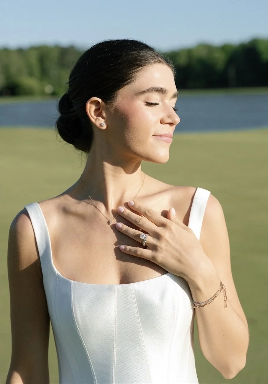 brunette bride gazing into the sunlight while standing on a golf course in atlanta