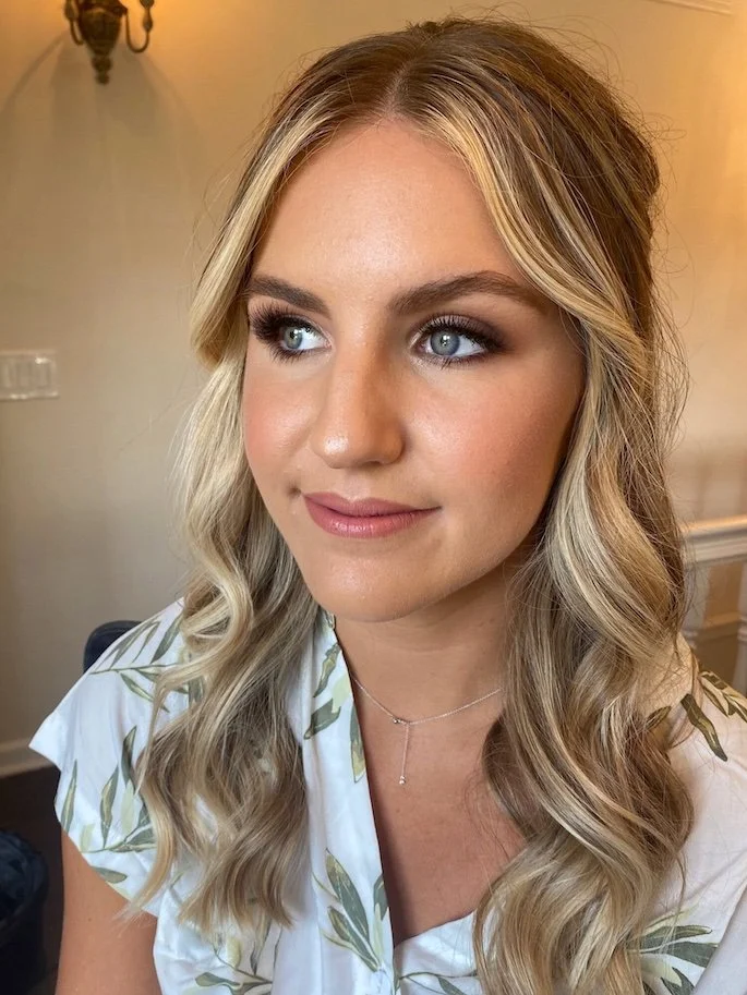 soft glam wedding makeup for a bride with blonde hair and blue eyes