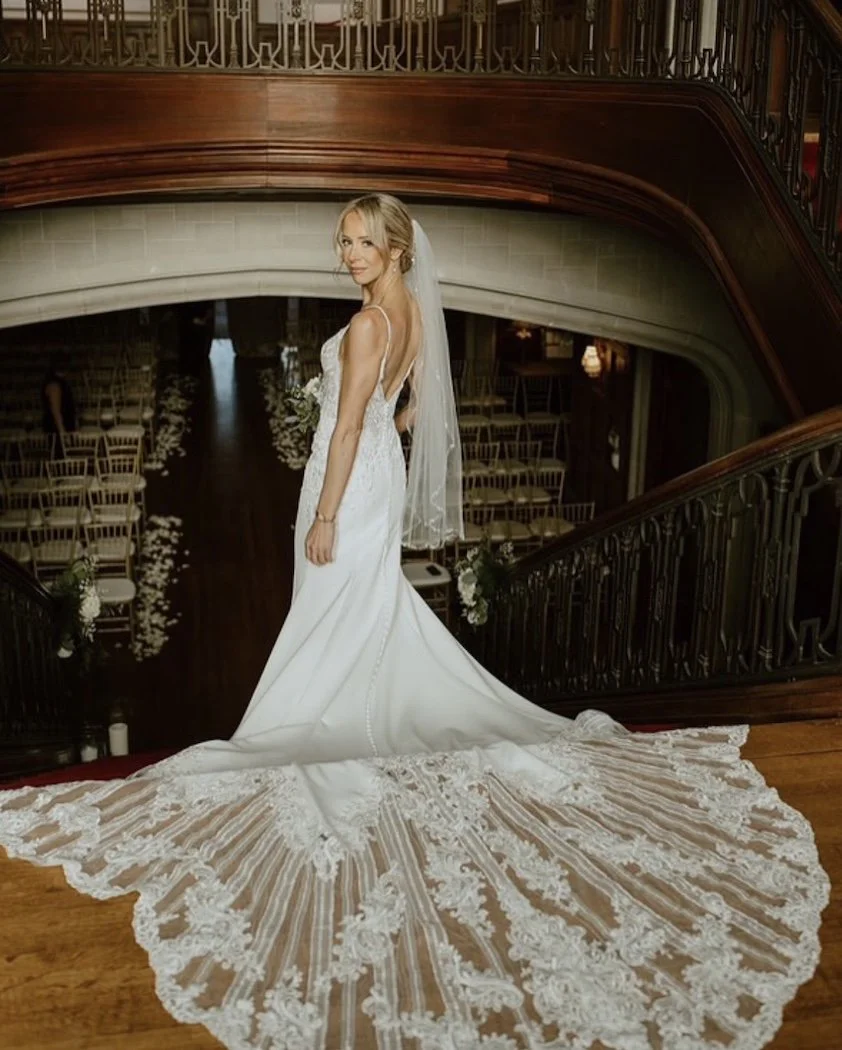 bridal portrait of a bride walking down the stairs at the callanwolde fine arts center in atlanta ga