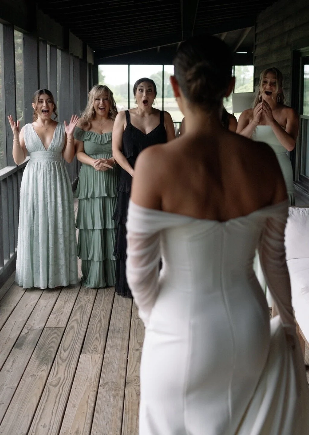 bride surprises her bridesmaids with a first look in her wedding dress