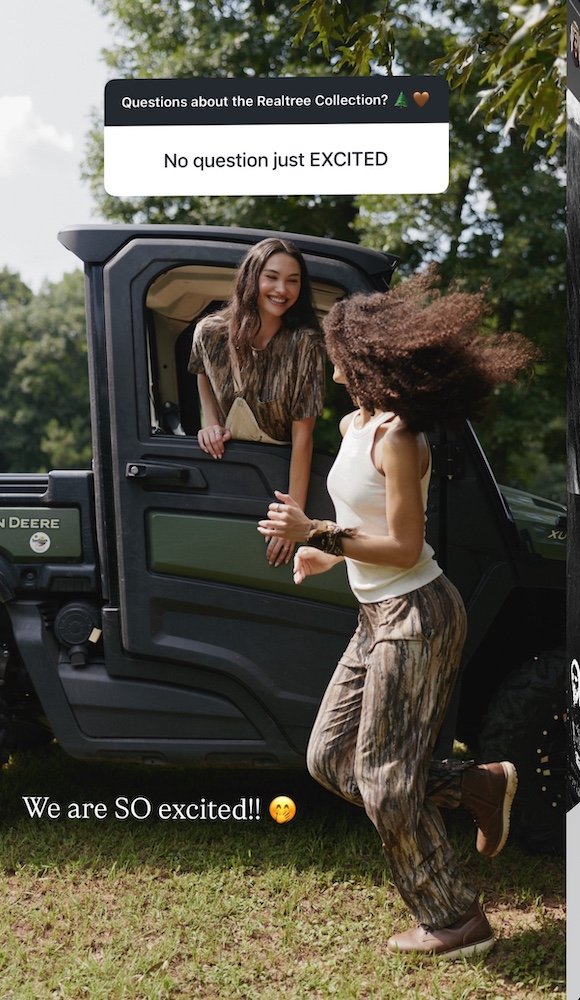 clothing brand photo shoot outside with two model by a john deer modeling clothing