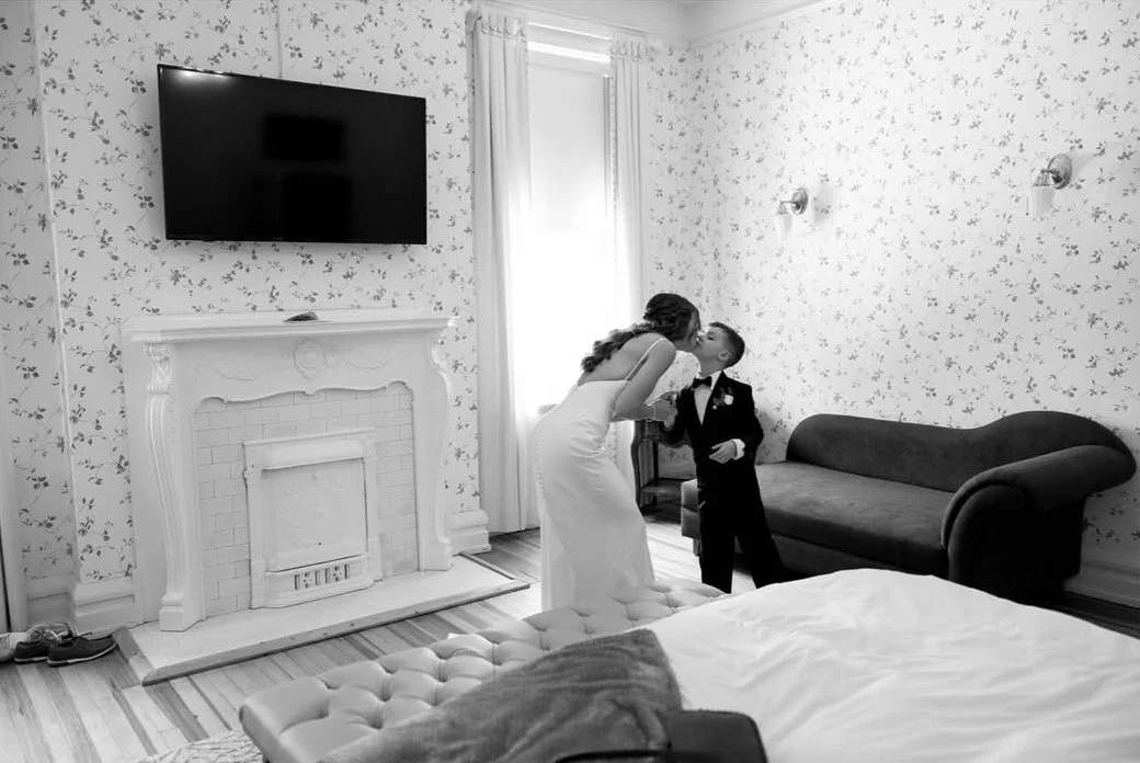 bride and young son share a kiss in the bridal suite before the ceremony in lagrange ga