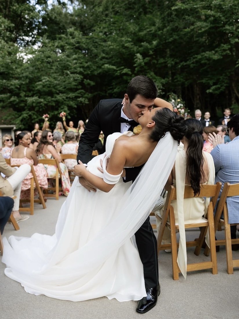 bride and groom kissing after they say I do