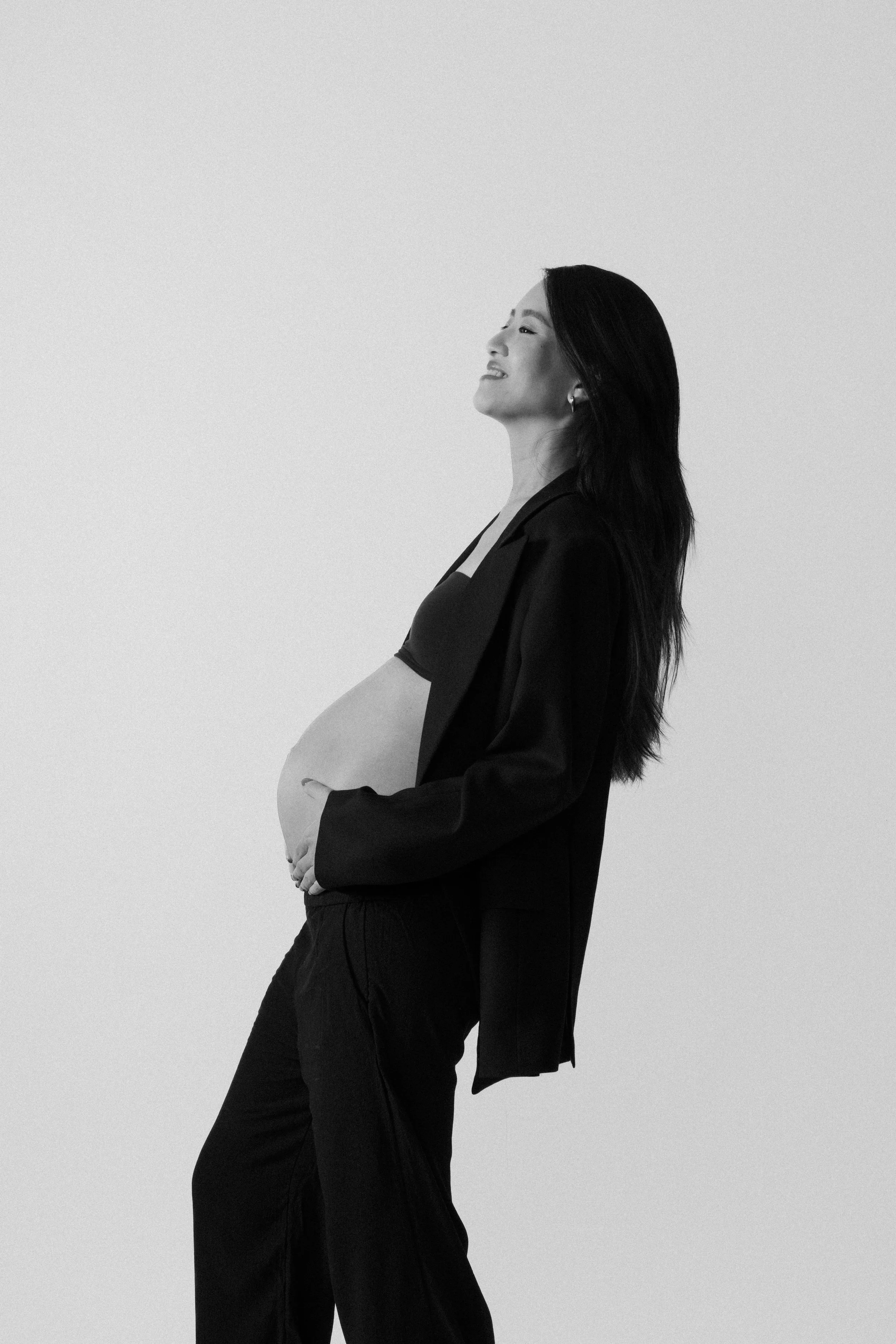 Backlit silhouette of Christina's pregnancy profile