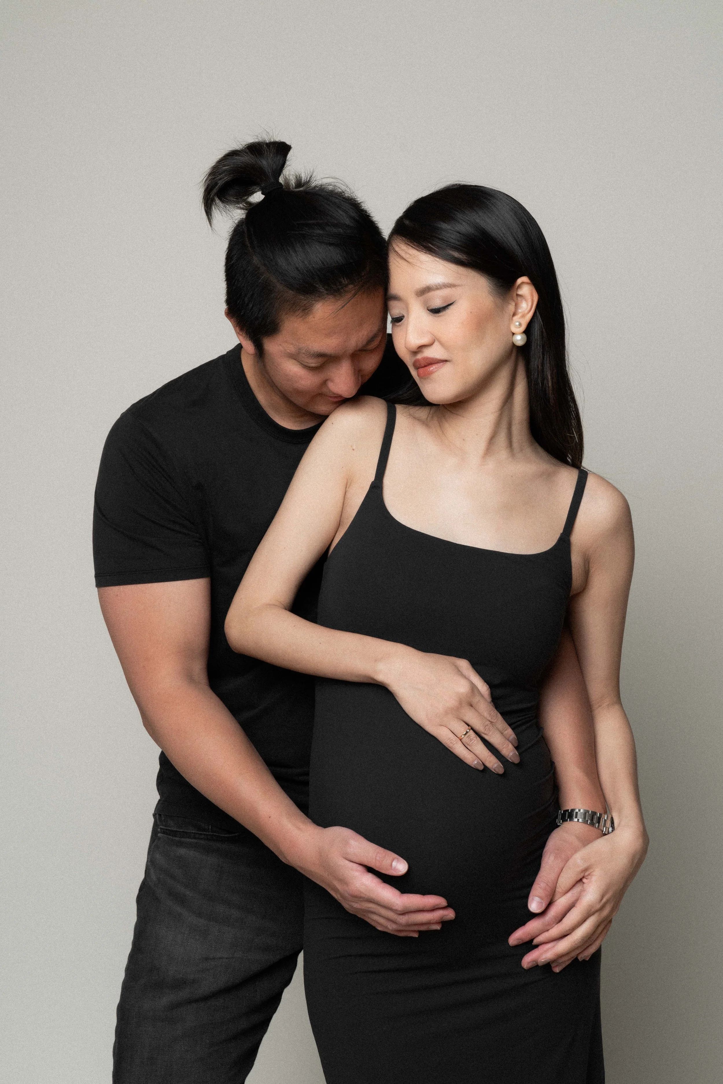 Christina and Mario embracing during their minimalist maternity photoshoot