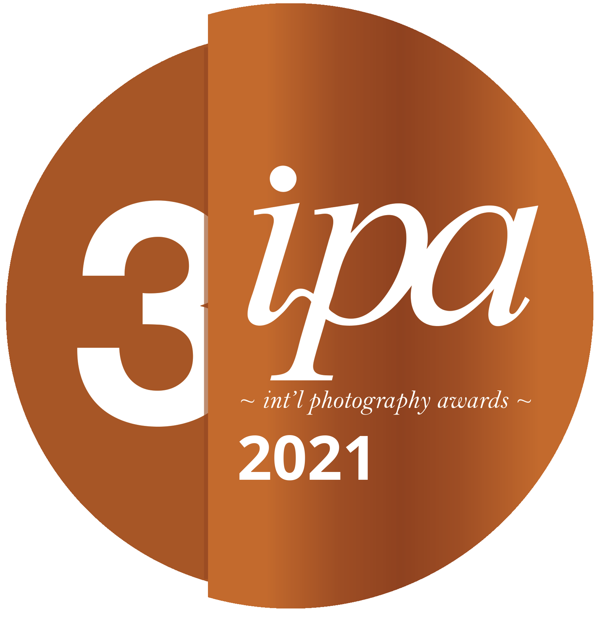 Logo for the 3rd annual 'iPA' International Photography Awards 2021, featuring a circular design with brown tones and the text '3ipa' and '~ int'l photography awards ~'.