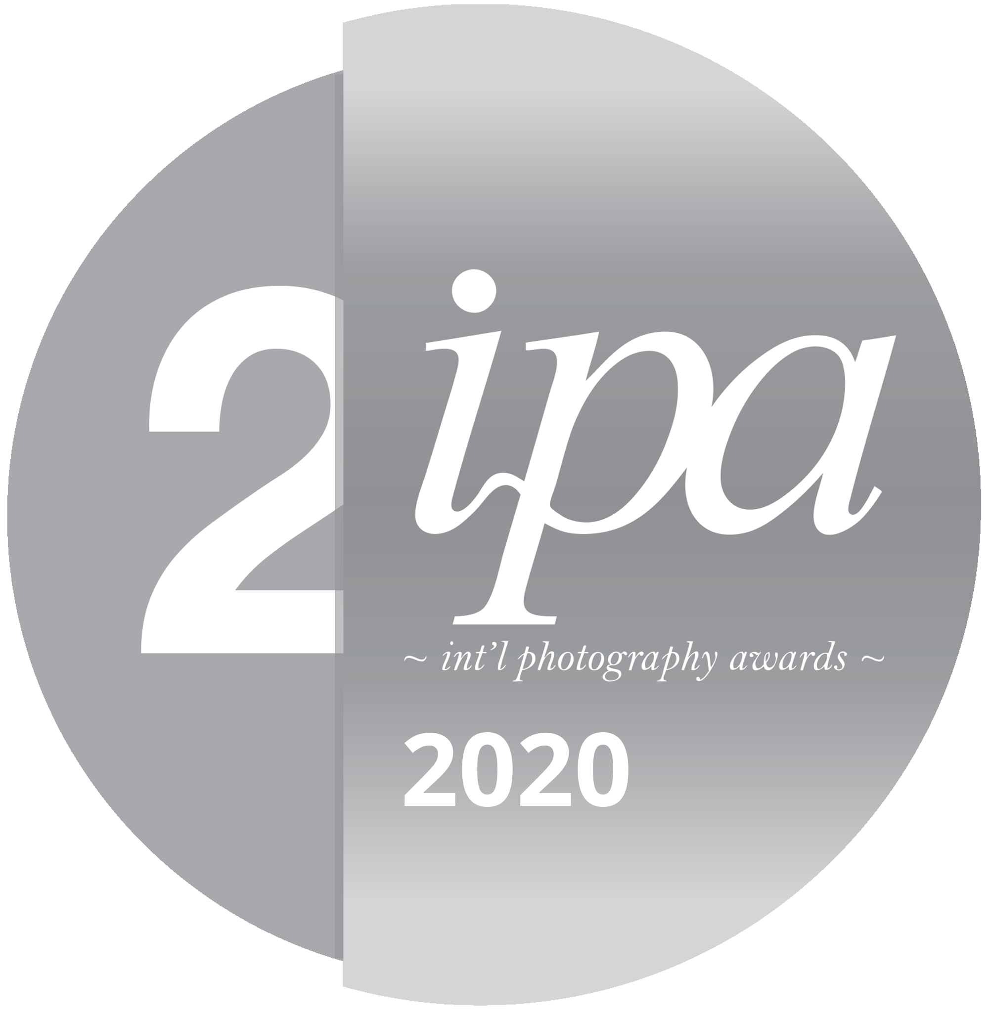 Gray circular award logo for 2IPA international photography awards 2020 with large number 2 and the word 'ipa' in script, and the text '~ int'l photography awards ~' below, with a gradient background.
