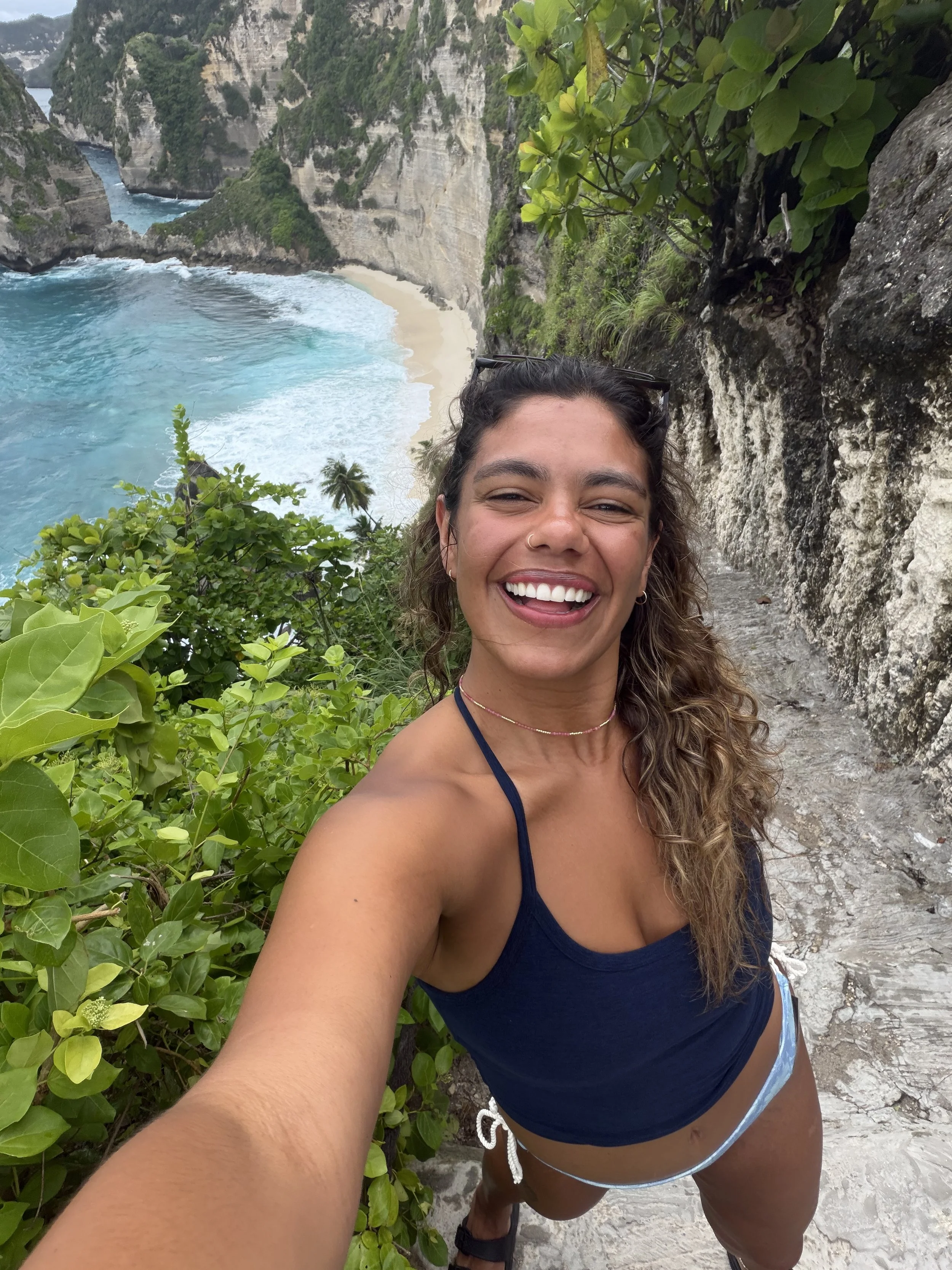 TAN GIRL SMILING WALKING DOWN STAIRS TO BEACH