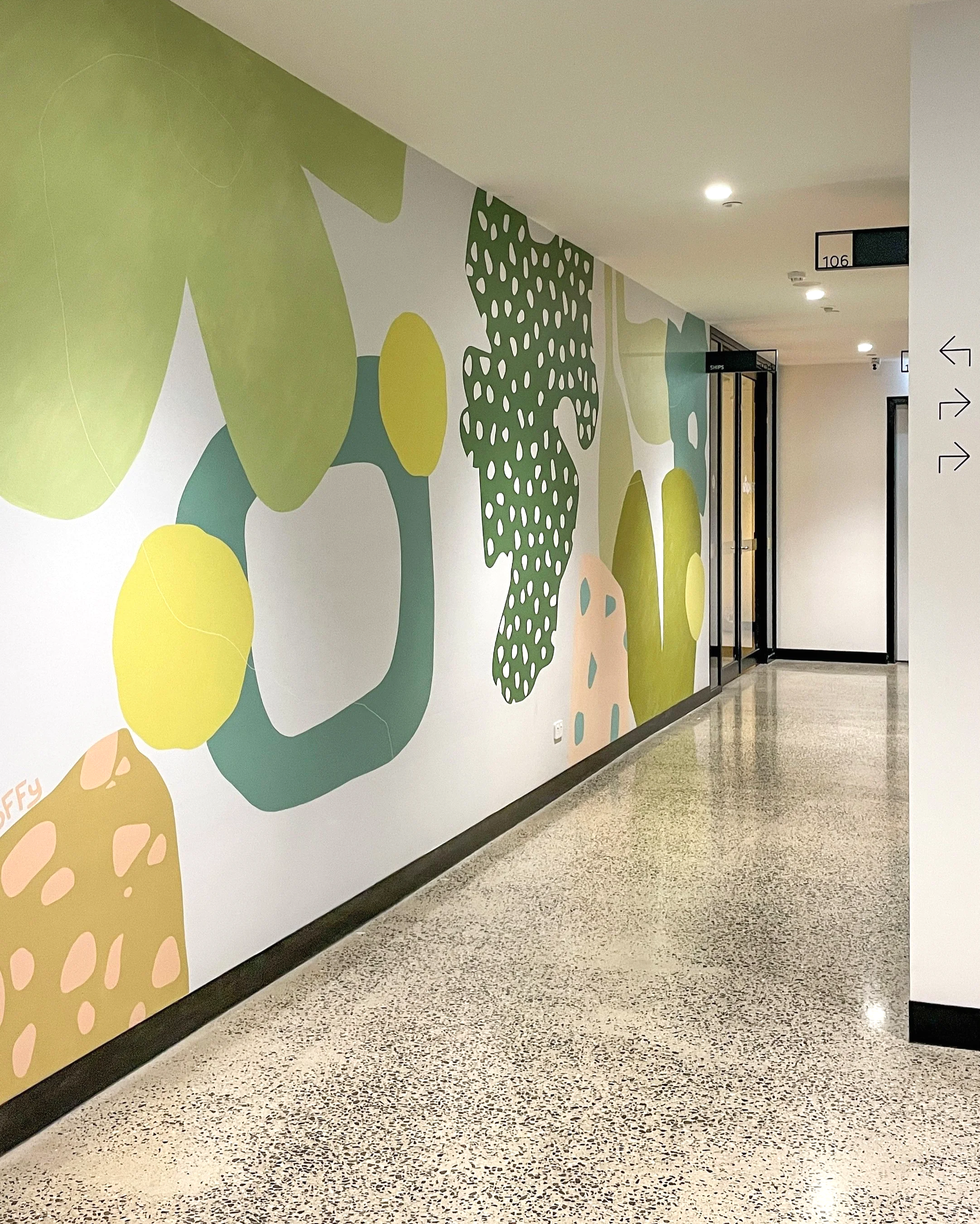 Interior mural installation 'Bee and Bloom' at East Brunswick Village, Melbourne, by mural artist Hoffy, featuring floral-inspired abstraction and organic forms.