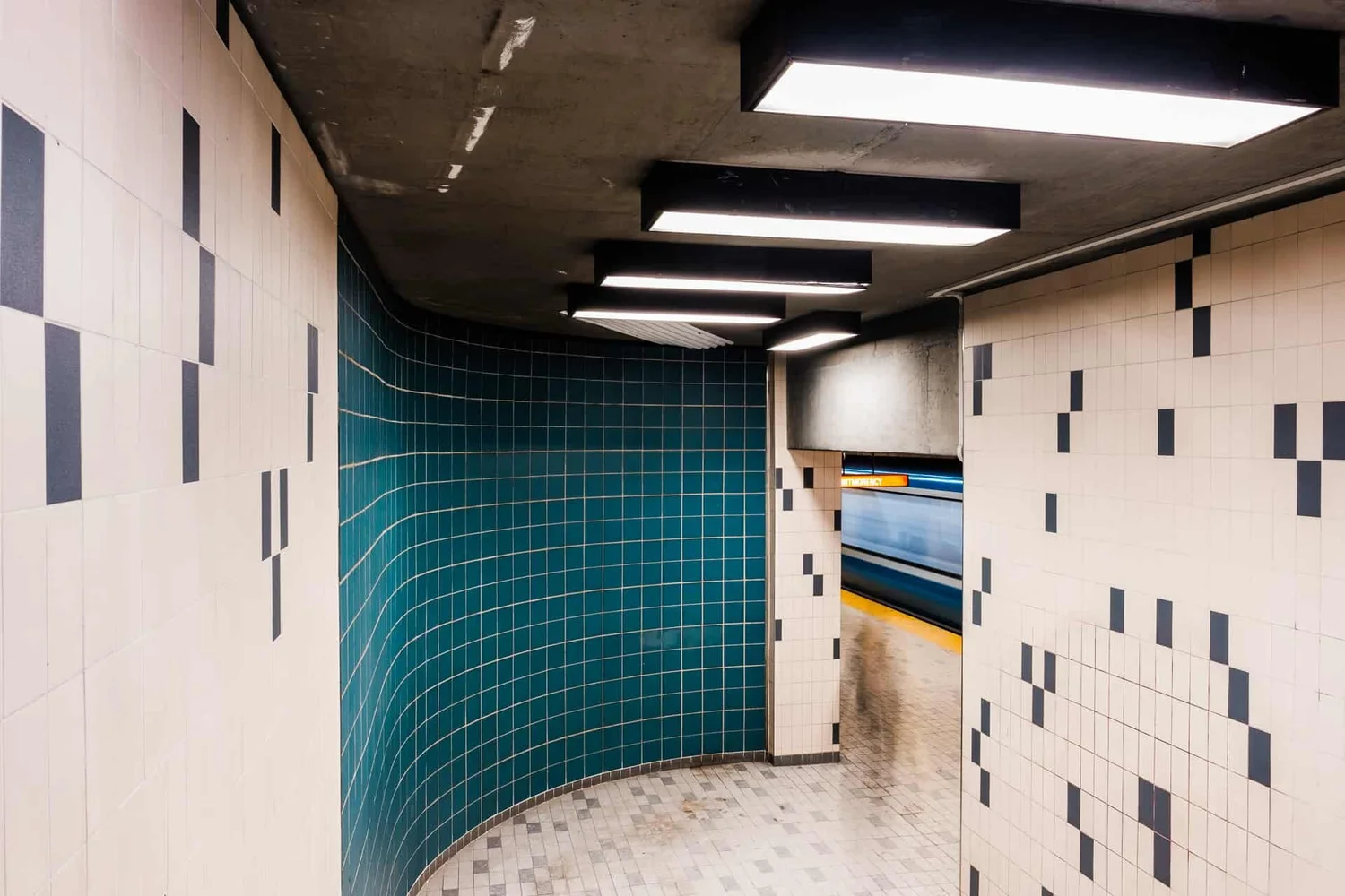 Métro Jarry — black and white diamond ceiling, escalator symmetry