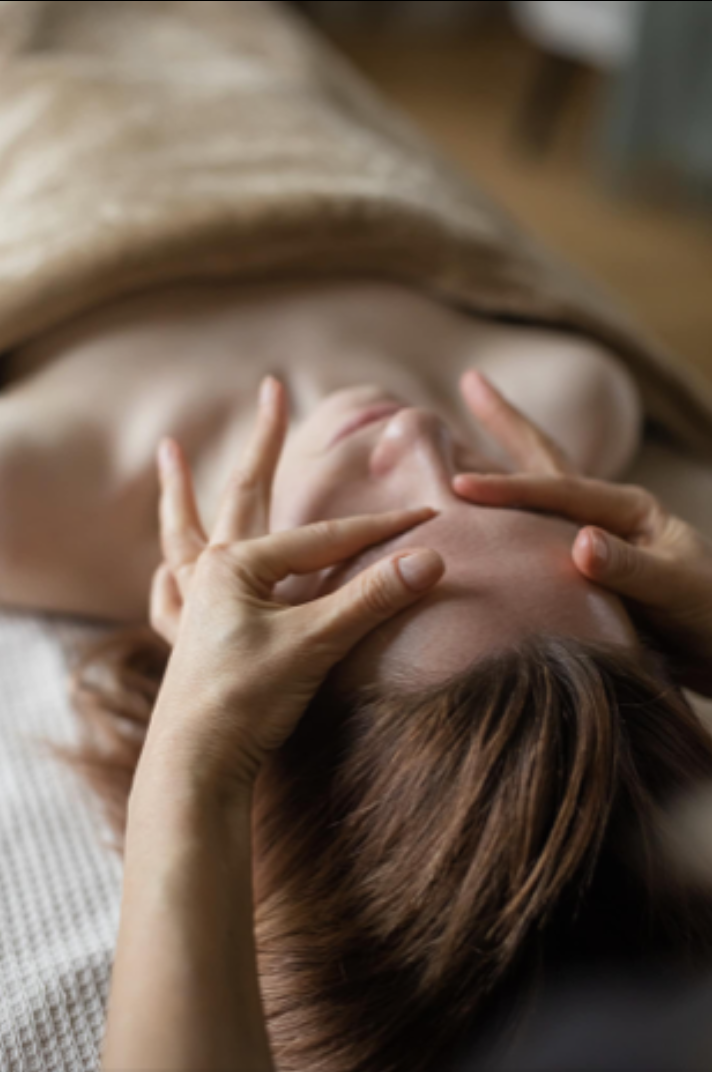 Therapist performing gentle Maka facial sculpting techniques on a female client