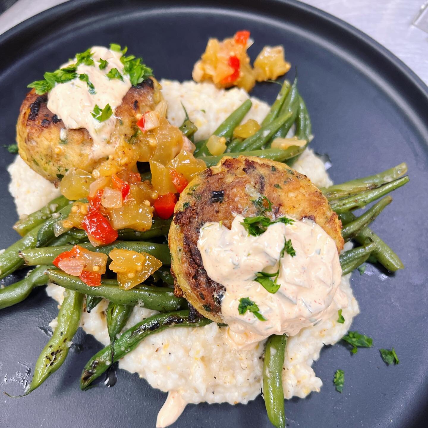 Lunch special | Trout cakes served with roasted garlic grits, saut&eacute;ed snap beans and topped with green tomato chow chow &amp; remoulade sauce