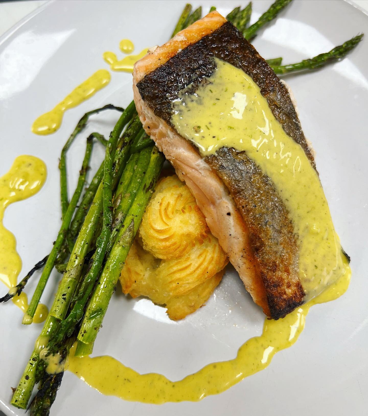 Poached Salmon served with grilled asparagus &amp; Dulchess potatoes &amp; topped with garden herb hollandaise