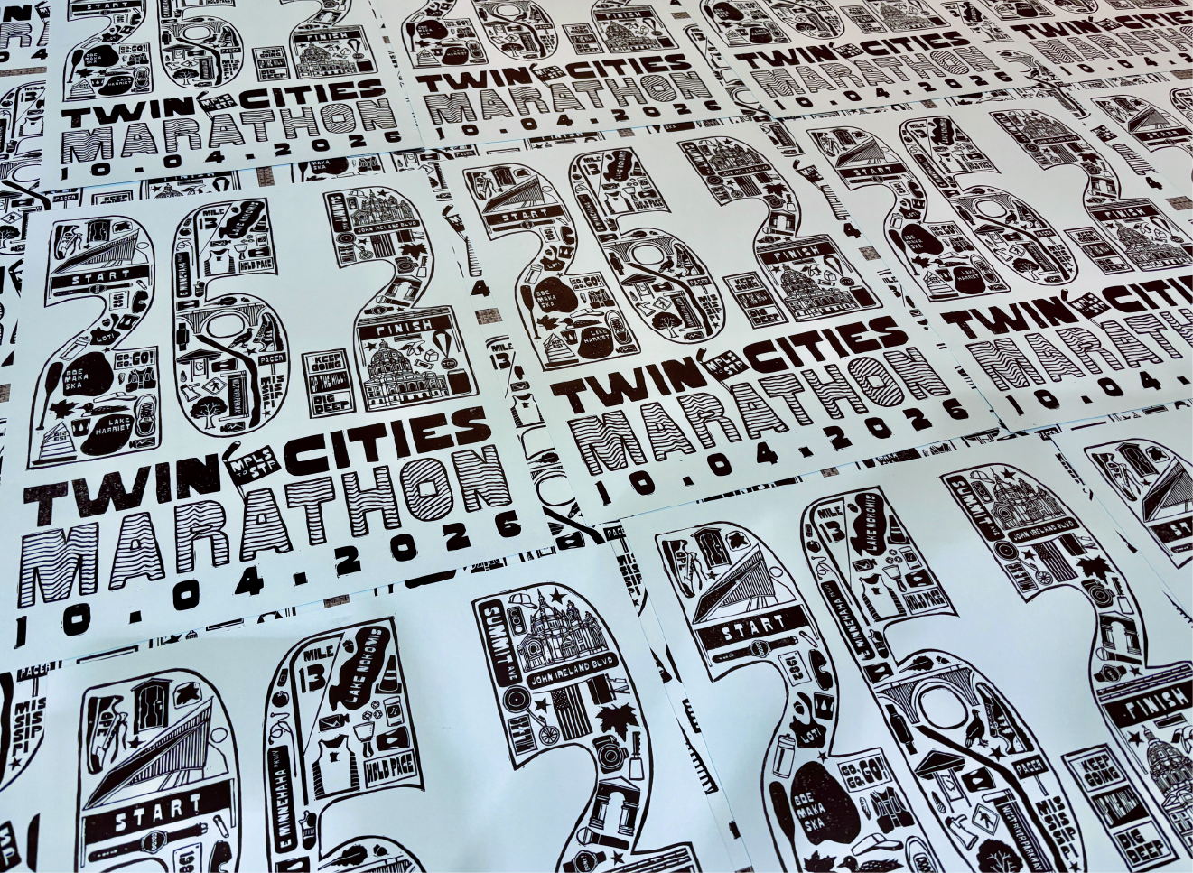 Repeated prints of the Twin Cities Marathon poster showing variations in ink coverage and texture