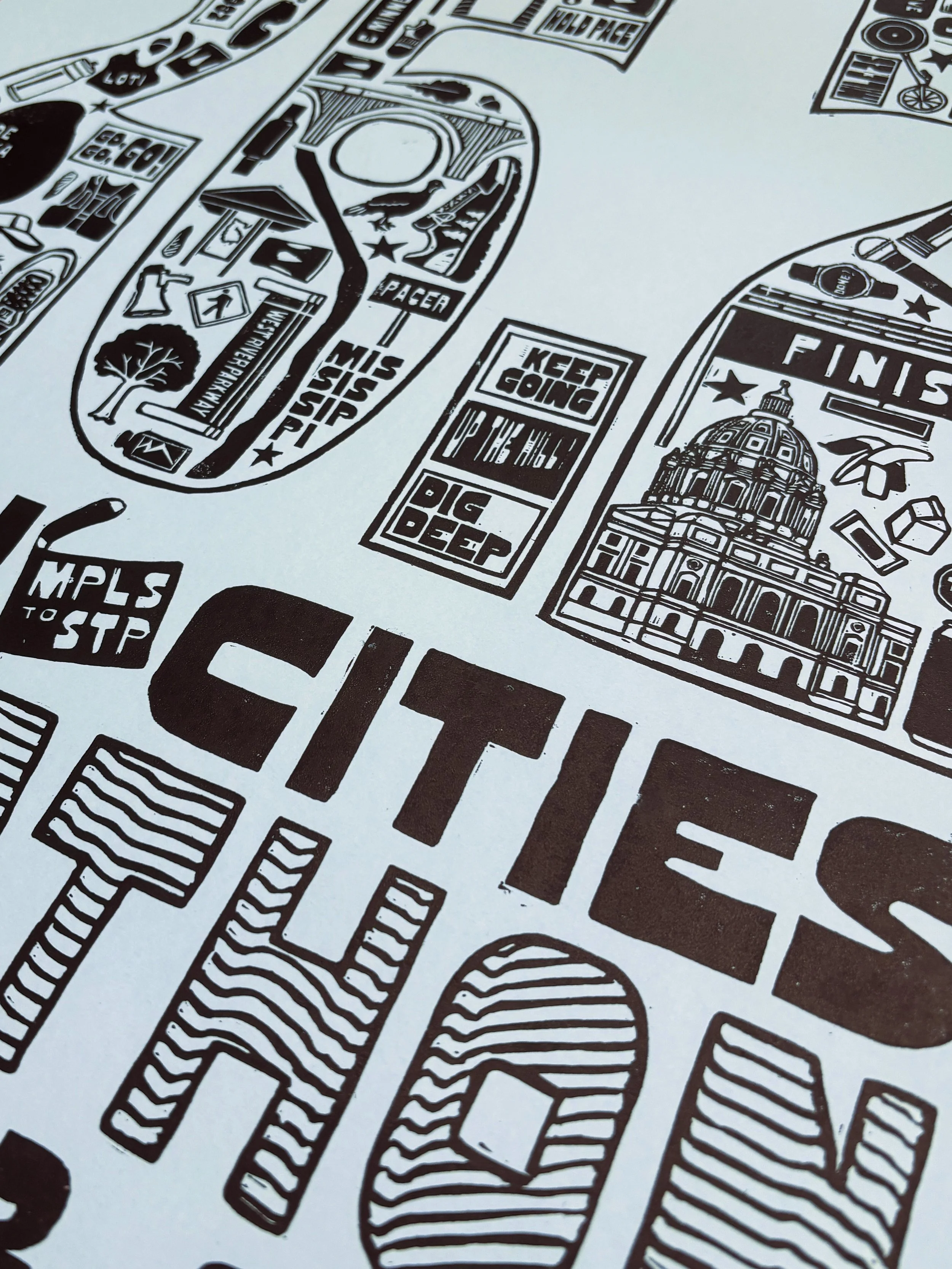 Close-up of Twin Cities Marathon poster showing hand-printed illustration and linocut texture