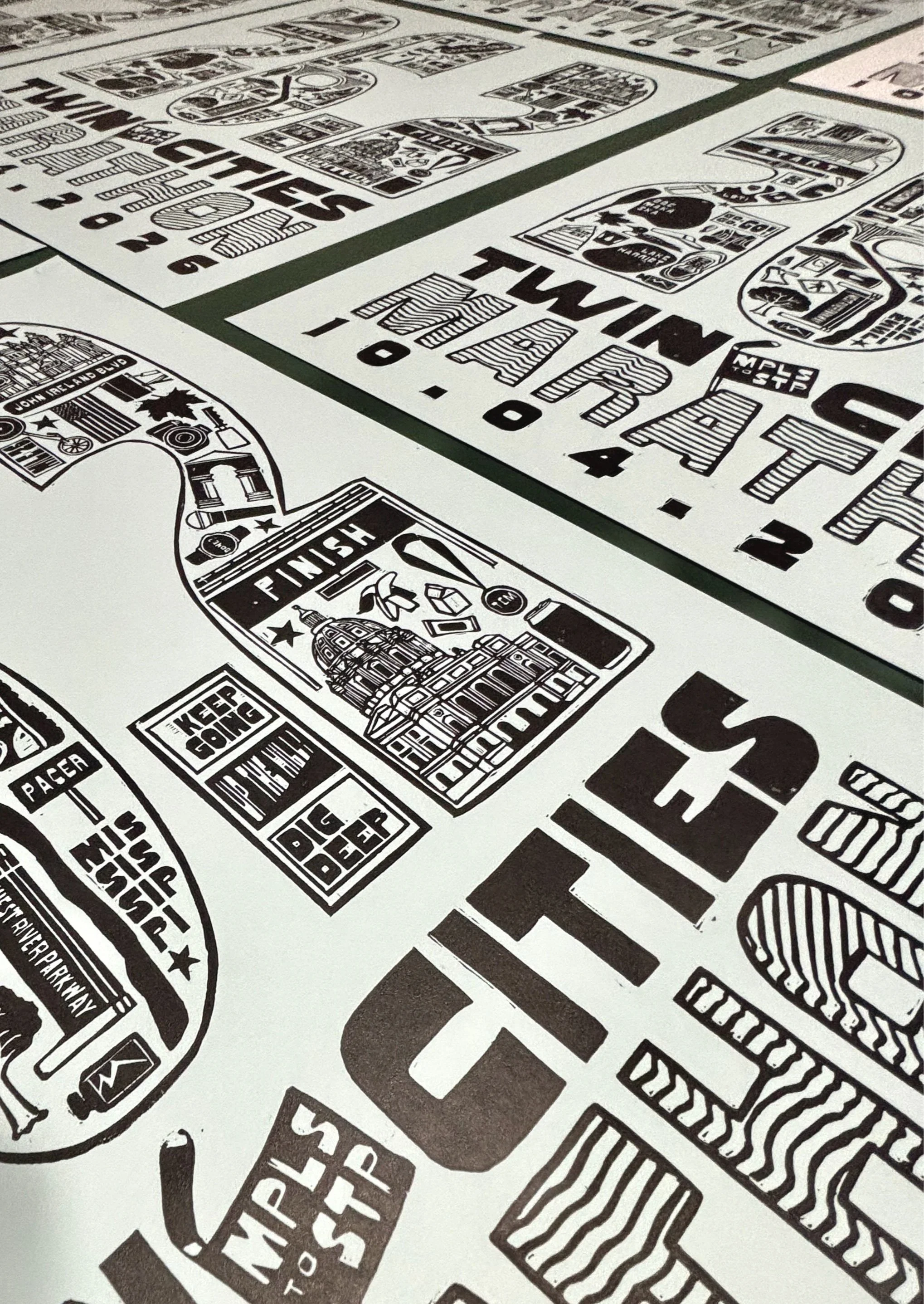 Close-up of the hand-printed Twin Cities Marathon poster showing illustrated landmarks and typography