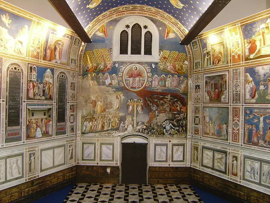 Interior of the Scrovegni Chapel in Padua, with Giotto’s frescoed walls and blue ceiling.