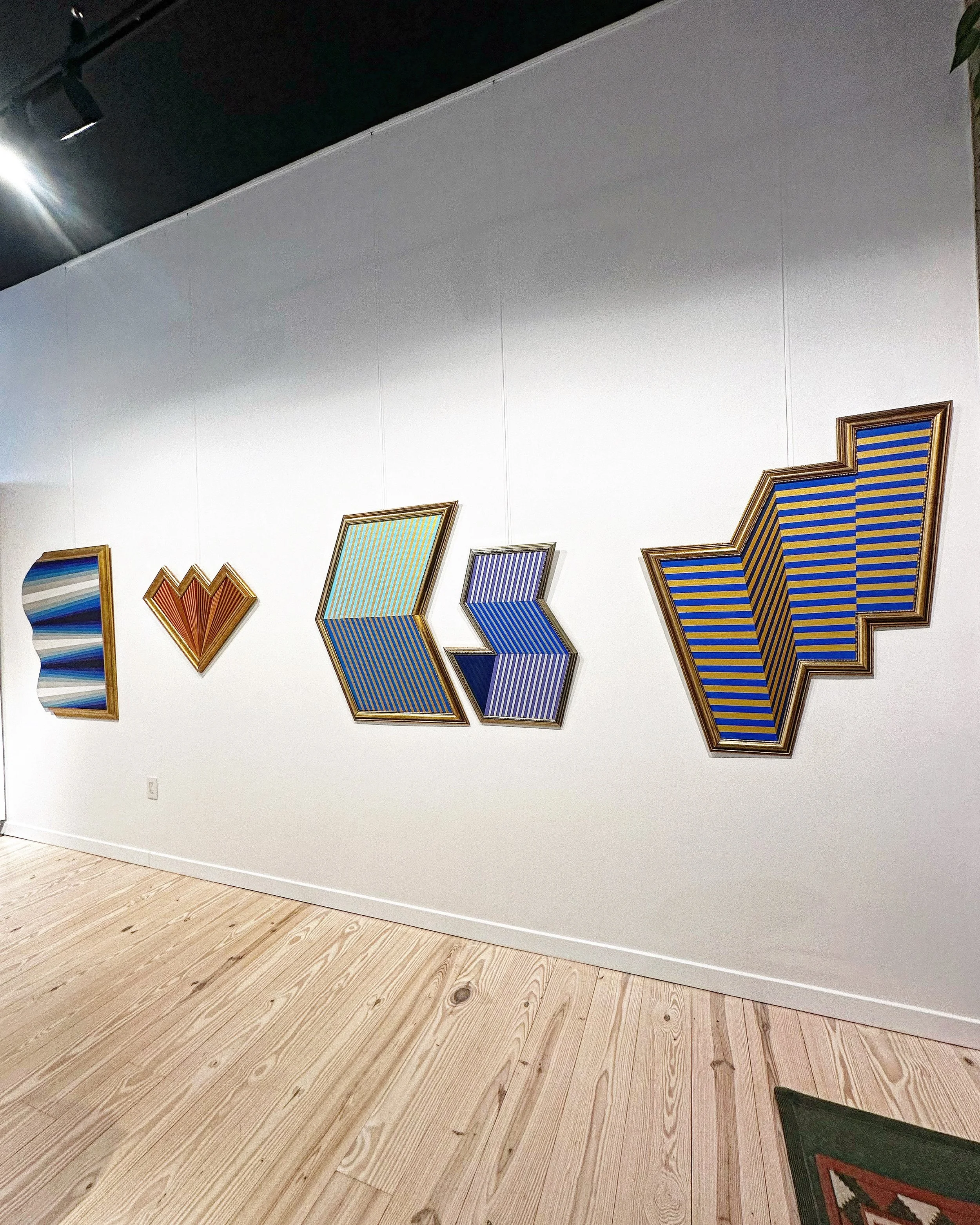 Contemporary artworks displayed with open wall space inside J. Nunez Gallery.
