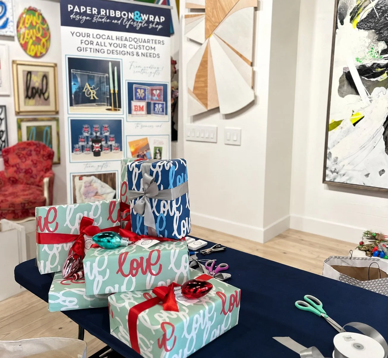 Gifts wrapped in limited-edition Love Always paper at the gallery wrapping table during the Christmas fundraising campaign.