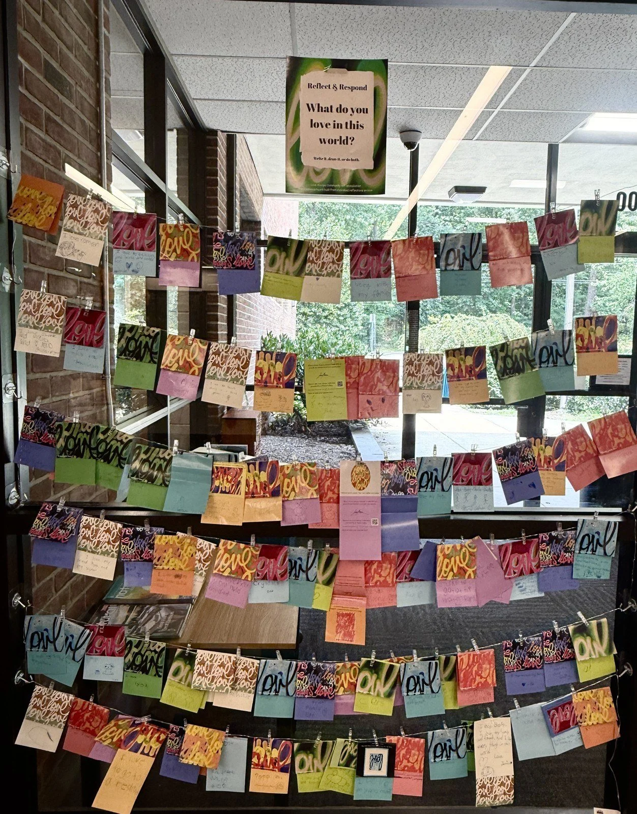 Love Always artwork cards and community responses displayed at Millburn Free Library.