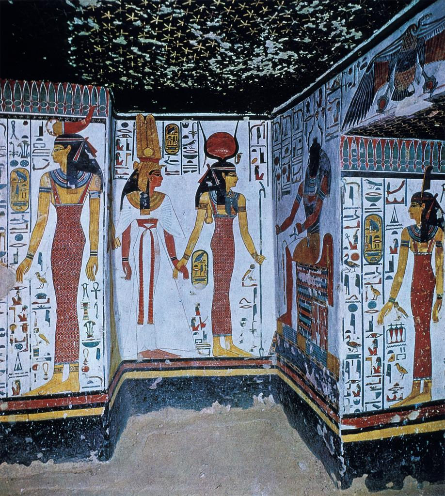 Ancient Egyptian painted figures and hieroglyphs beneath a dark blue ceiling covered with stars.