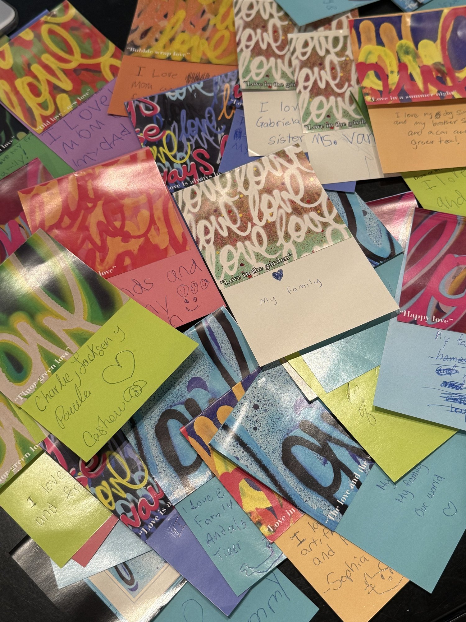 Love Always community art installation at Millburn Free Library, displaying contributions from local participants.