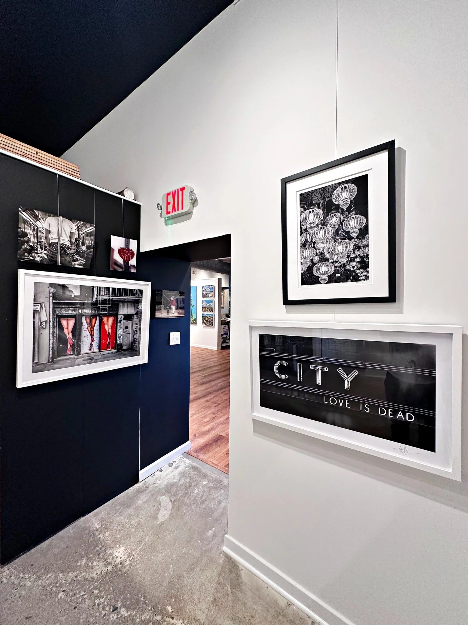 Interior of J. Nunez Gallery in Summit, New Jersey, featuring framed fine art photography displayed on black and white walls.
