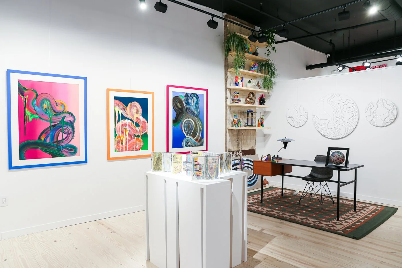 Interior of J. Nunez Gallery in Millburn, New Jersey, displaying colorful contemporary artworks, sculptures and original art.