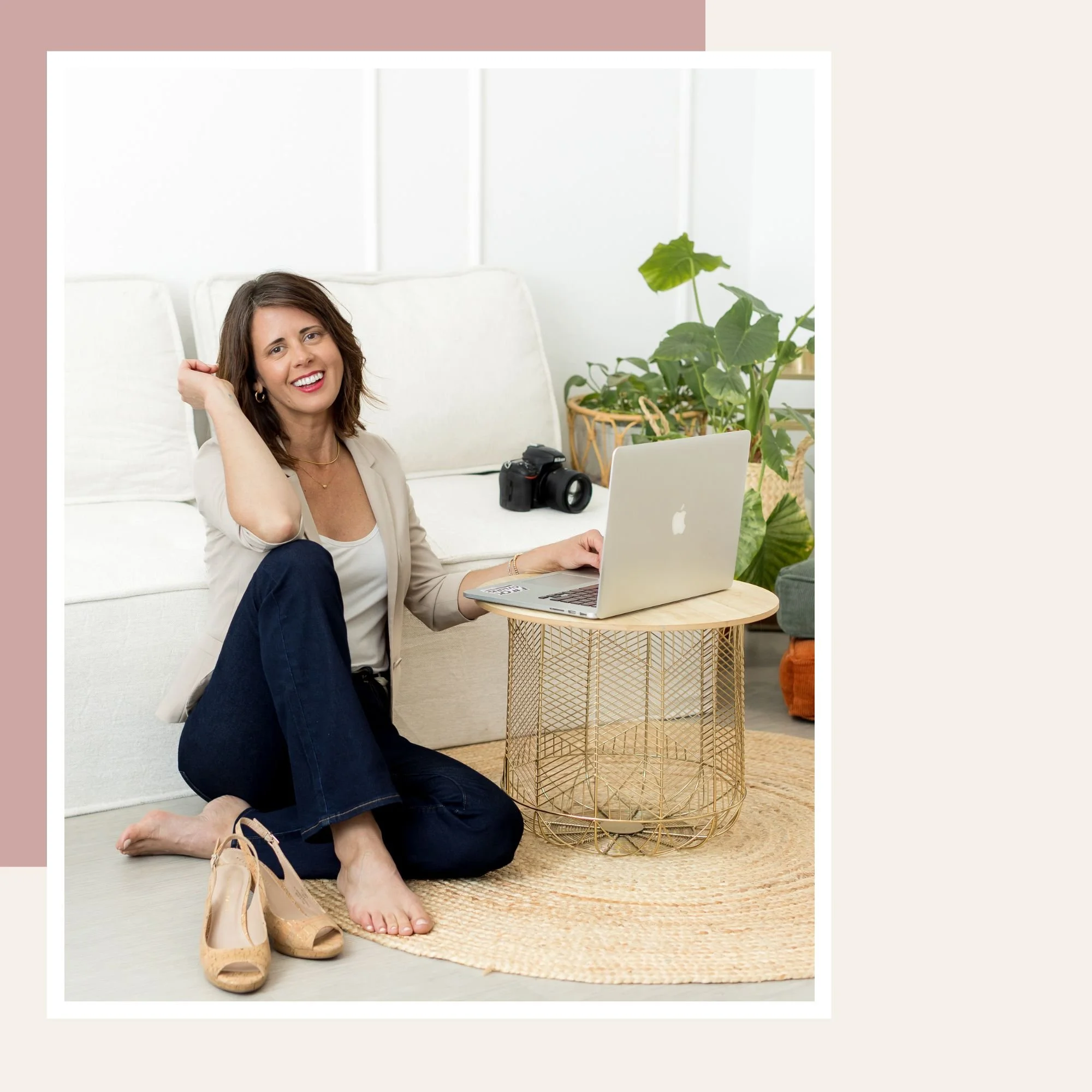 Carina Fleckner smiling near her computer, ready to connect with new personal branding photography clients in San Diego