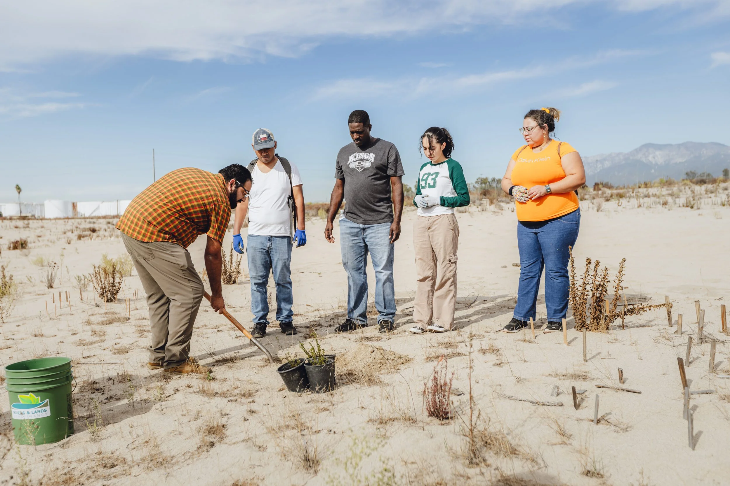 Michael Viramontes, stewardship manager at Rivers and Lands Conservancy, walks student volunteers from Moreno Valley College through planting California buckwheat in Colton, CA. October 25, 2025.
