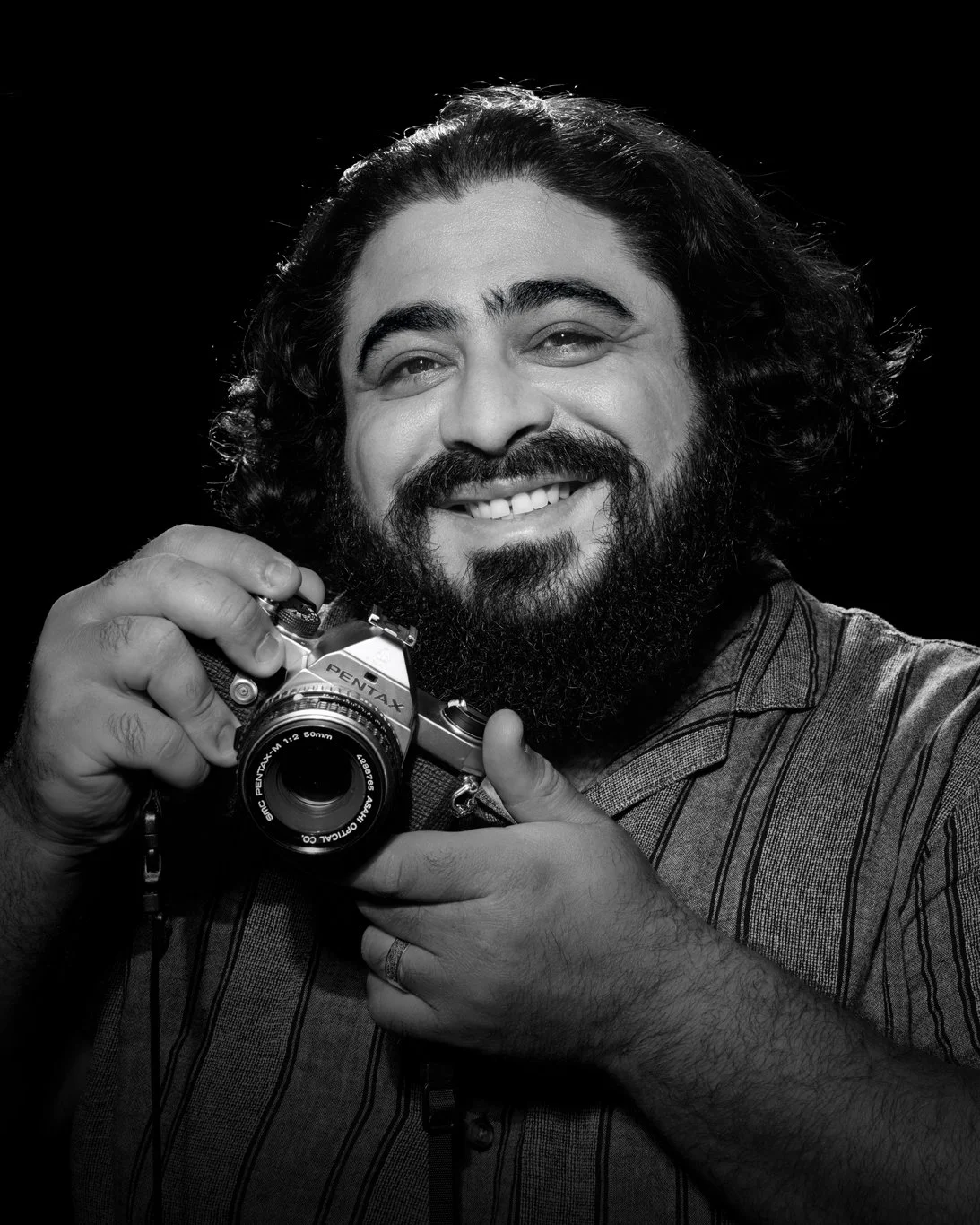 Black and white image of man holding a camera