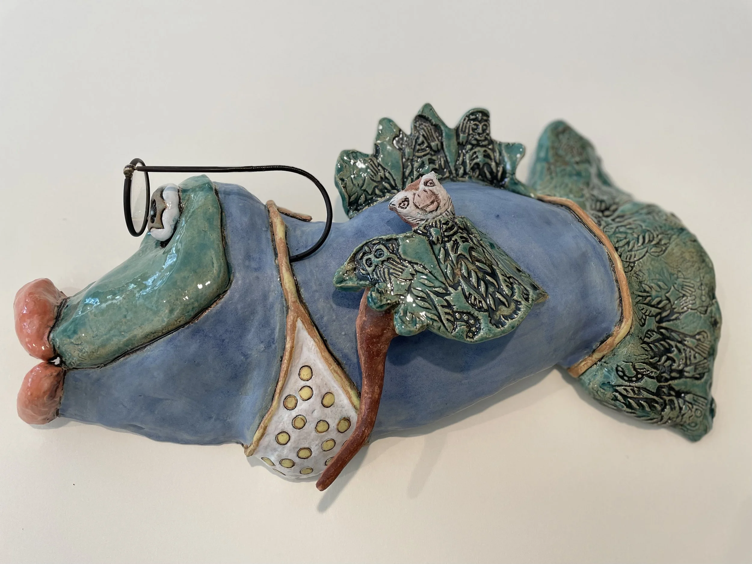 Darrci Robertson  
The Monkey in Disguise
This is a wall piece made of clay and metal.  Handbuilt using lowfire glazes.  Fired to cone 06.
14 x8 x 4 
2026
$220.00