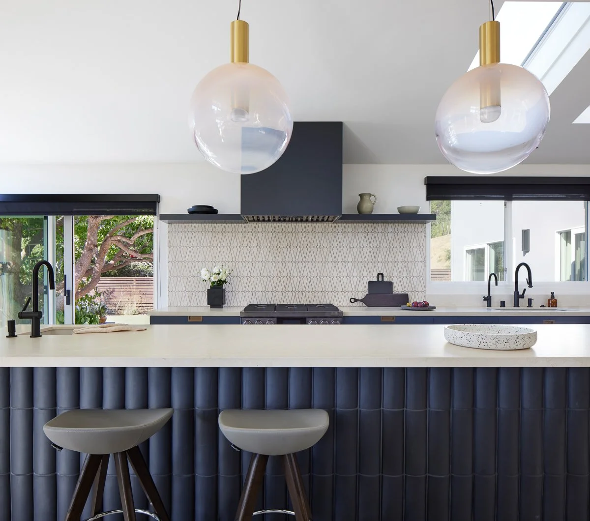 white spacious seating and working counter in modern renovation by gamble + design