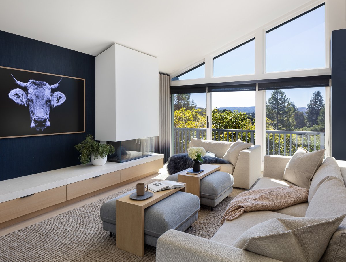 living room view with fireplace and table ottomans by gamble + design