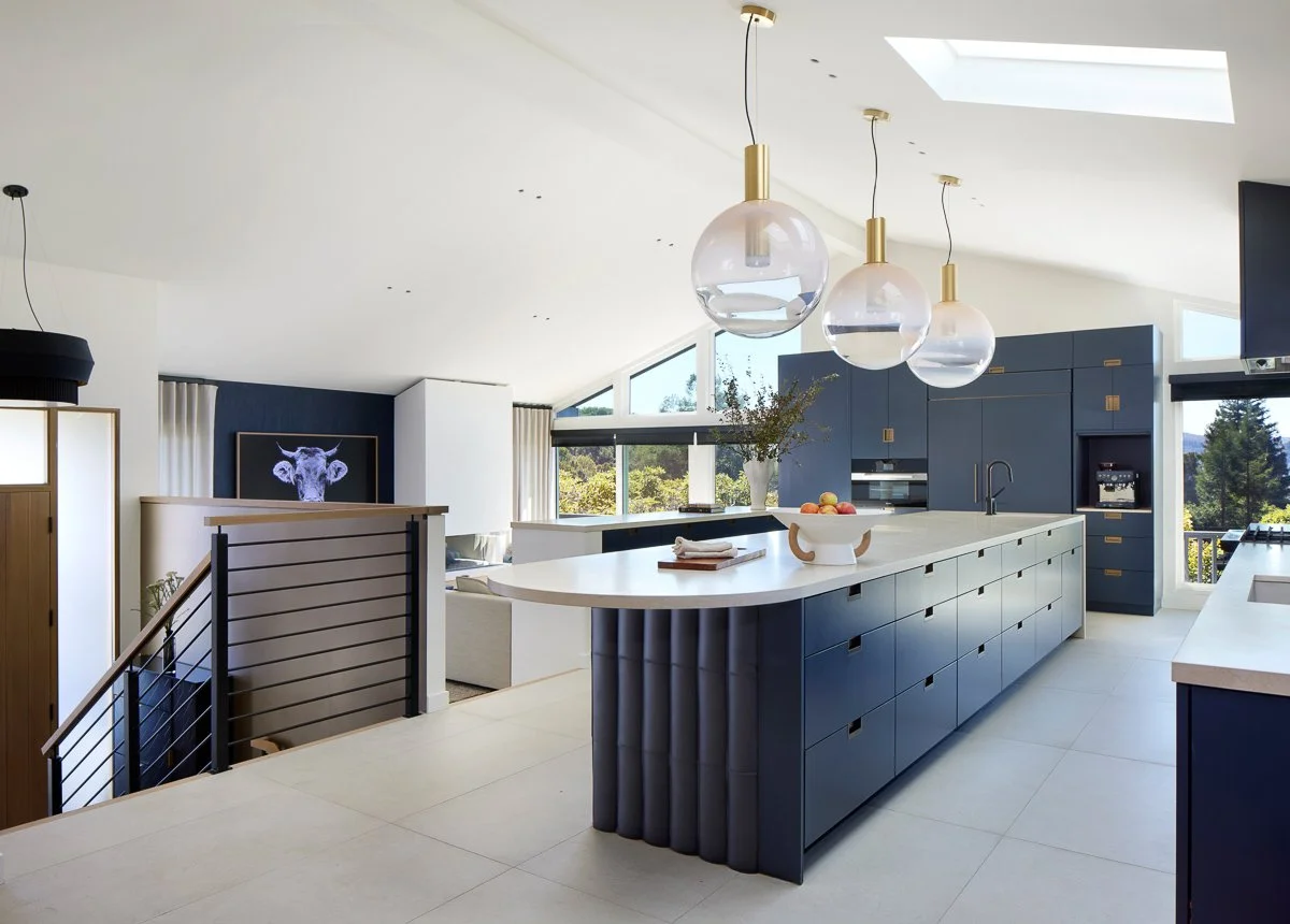 modern kitchen island counter by gamble + design with round end and overhead lighting