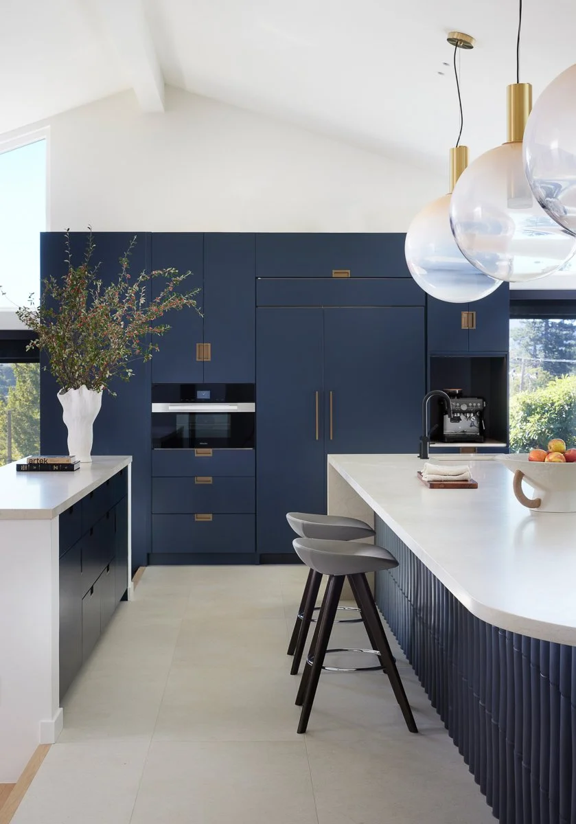 kitchen counter with back wall of kitchen cabinets and built in appliances