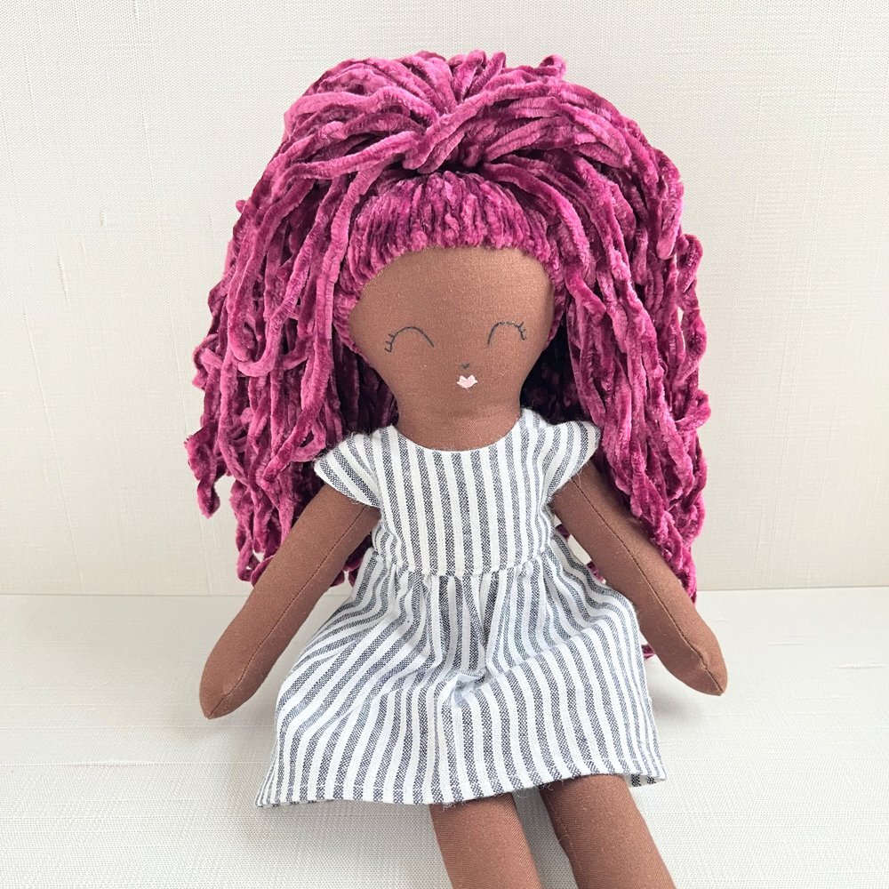 Meet Ida 🥰

Ida wants to be a writer. She loves asking questions, and she&rsquo;ll be eager to share your story!

Ida is handmade-to-order and has dark brown skin with super soft curly black hair, tied in a ponytail. Just choose her outfit, and she&