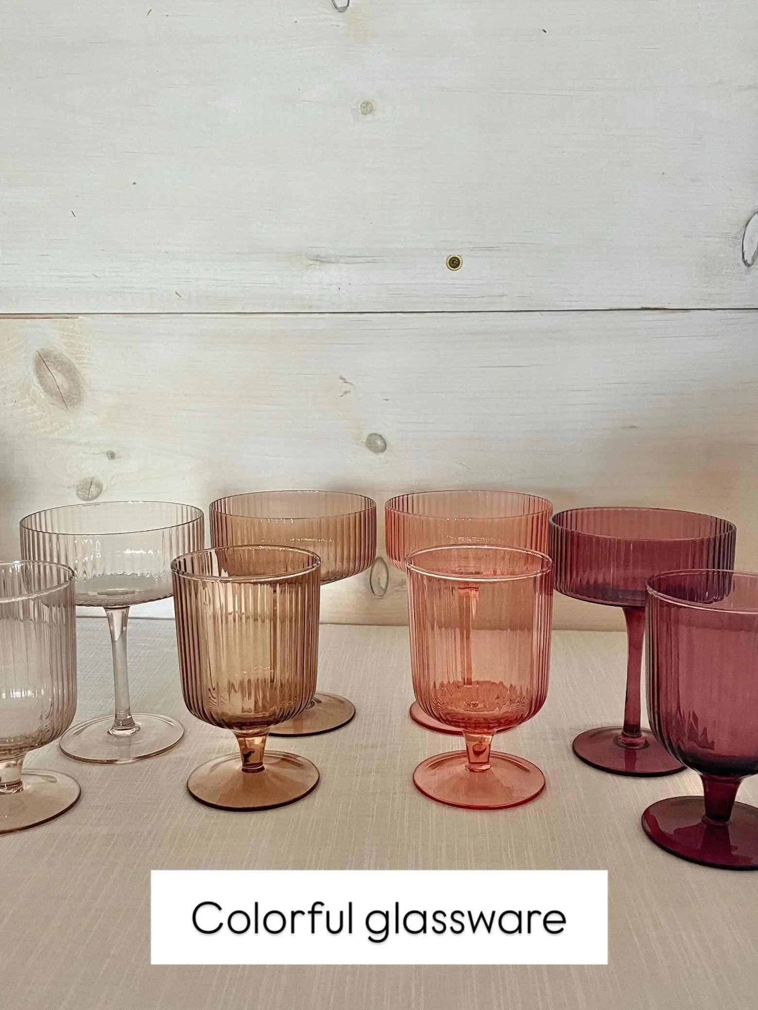 Colorful glassware- champagne coupes and wine glasses in shades of pink &amp; wine