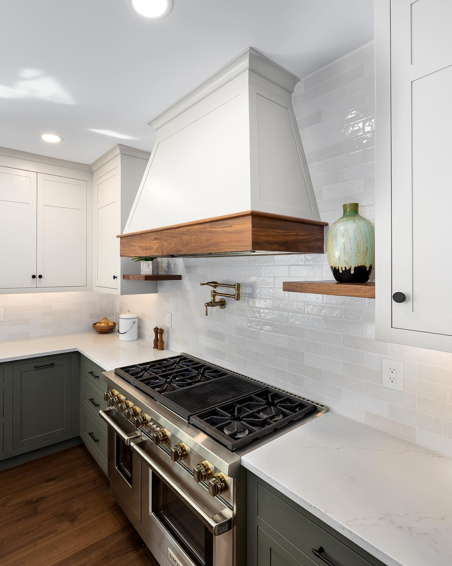 Sharing a few more details of this show stopping kitchen! The custom designed hood surround is trimmed with natural walnut. Complemented by the finished floor, the walnut accents really tie everything together!

#customcabinets #cabinetmaker #customk