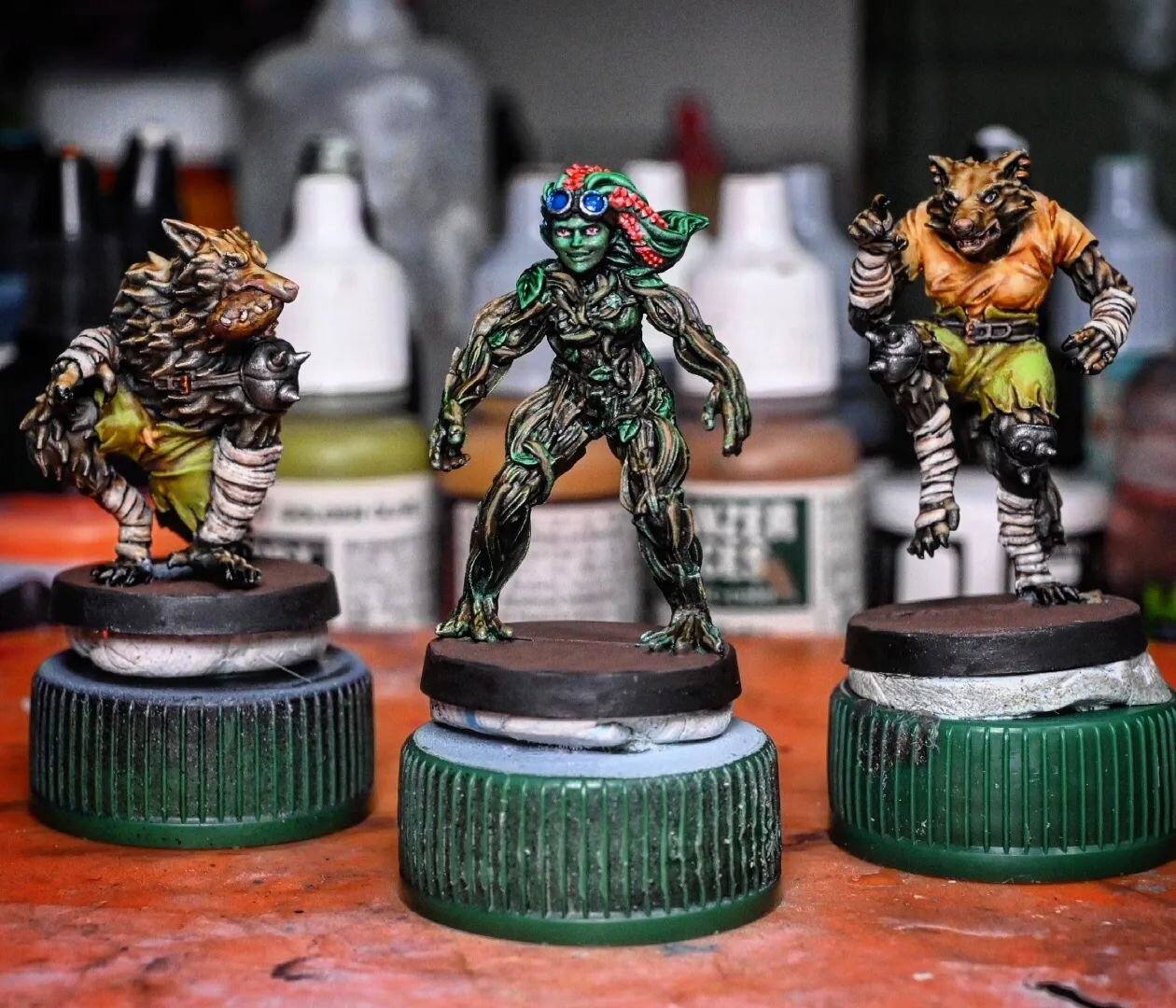 Finished painting the two werewolves and the dryad over the weekend, including some fun UV-fluorescent ink on the dryad's hair and face. Not calling them &quot;done&quot; yet since they still need basing material, but I'll be doing bases in a big bat