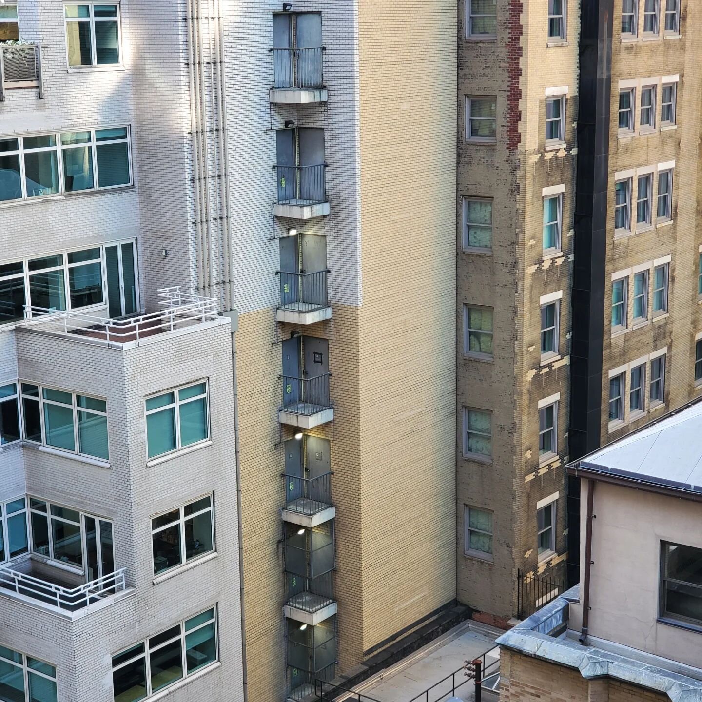Finally found the balcony on the floor below us at the office, went out to get some fresh air and check out the view. Then noticed this architectural headscratcher across the street. Wtf? First glance, I assumed it was a fire escape; but there's no w