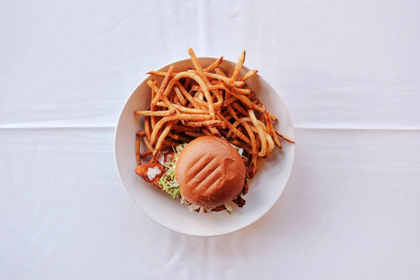 Crispy, creamy, and packed with flavor 🍗✨
Our Fried Chicken Caesar Sandwich layers a chicken milanese cutlet with lettuce slaw, caesar dressing, black pepper aioli, and Parmigiano on a buttery brioche roll. Served with your choice of greens or frite