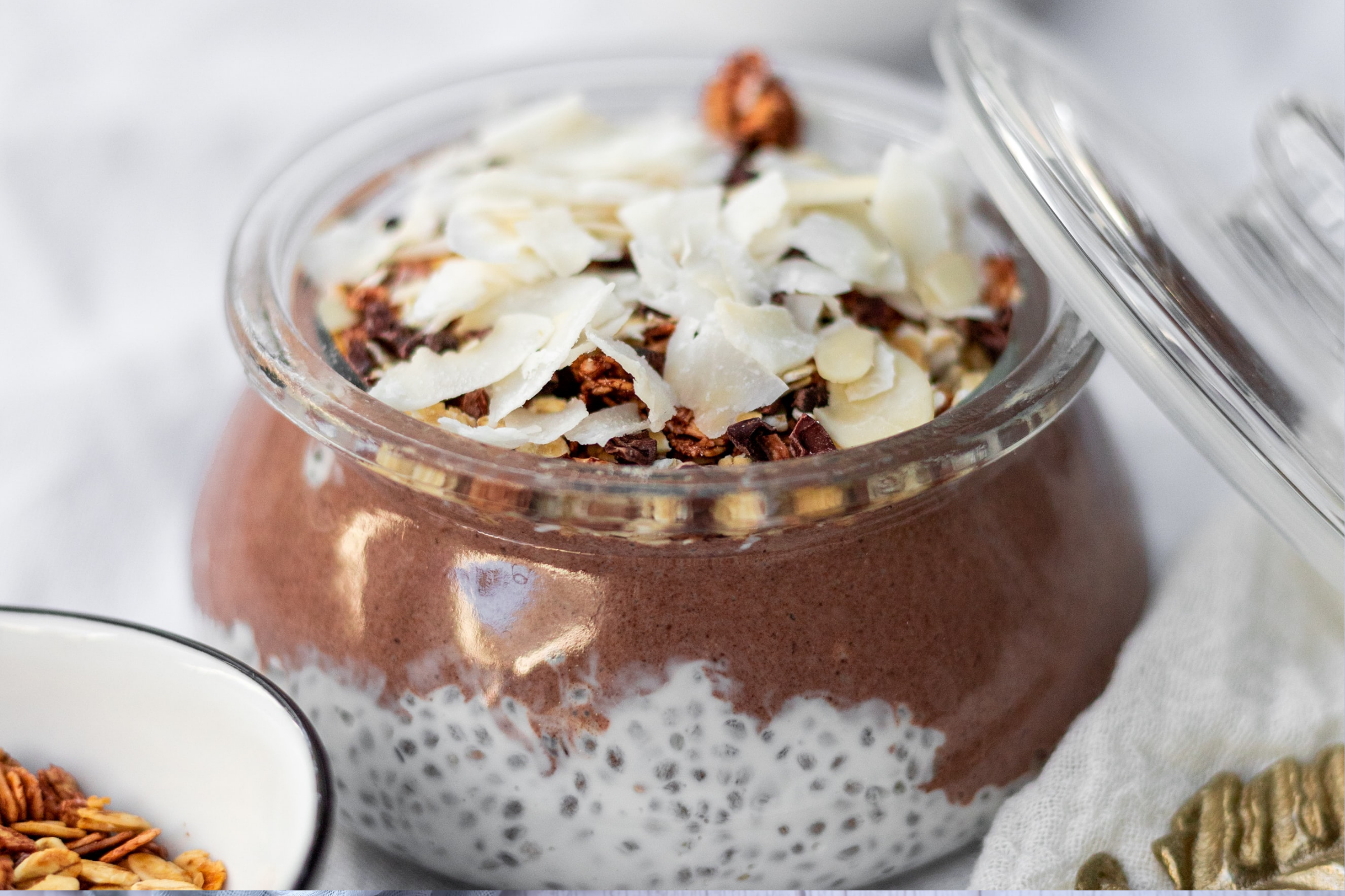 Almond Joy chia pudding with coconut flakes in a pretty jar