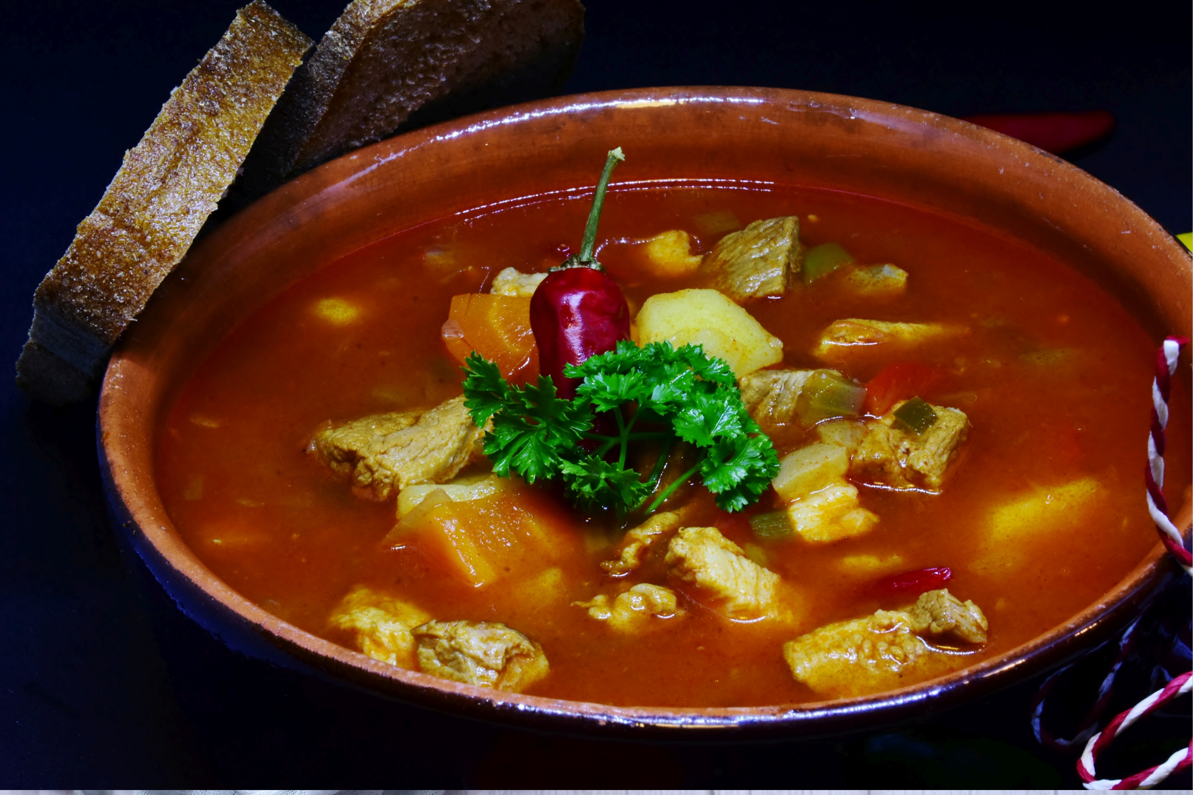 Mexican chicken and vegetable soup in a pottery bowl