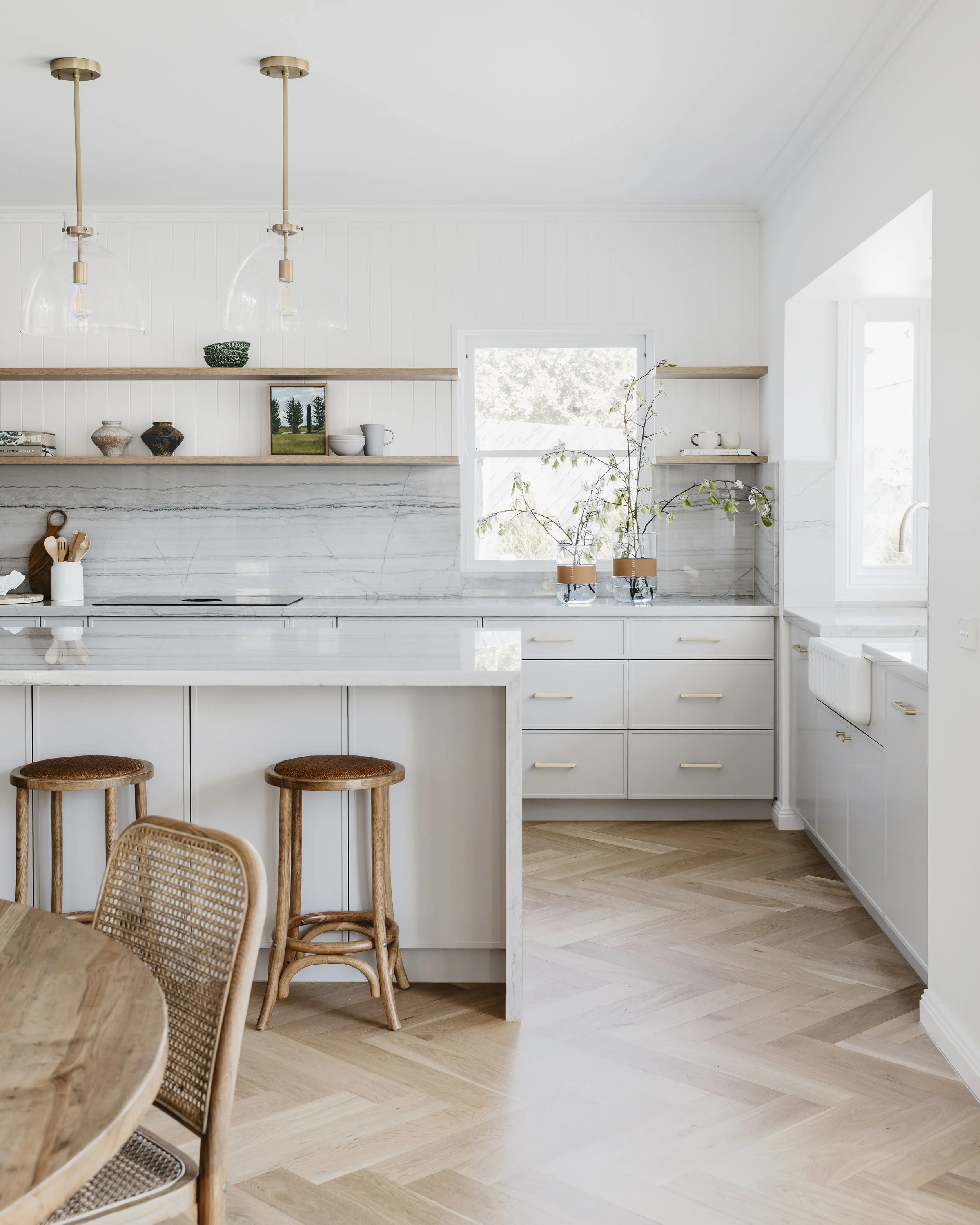 Beautiful modern kitchen interior with marble backsplash and natural light