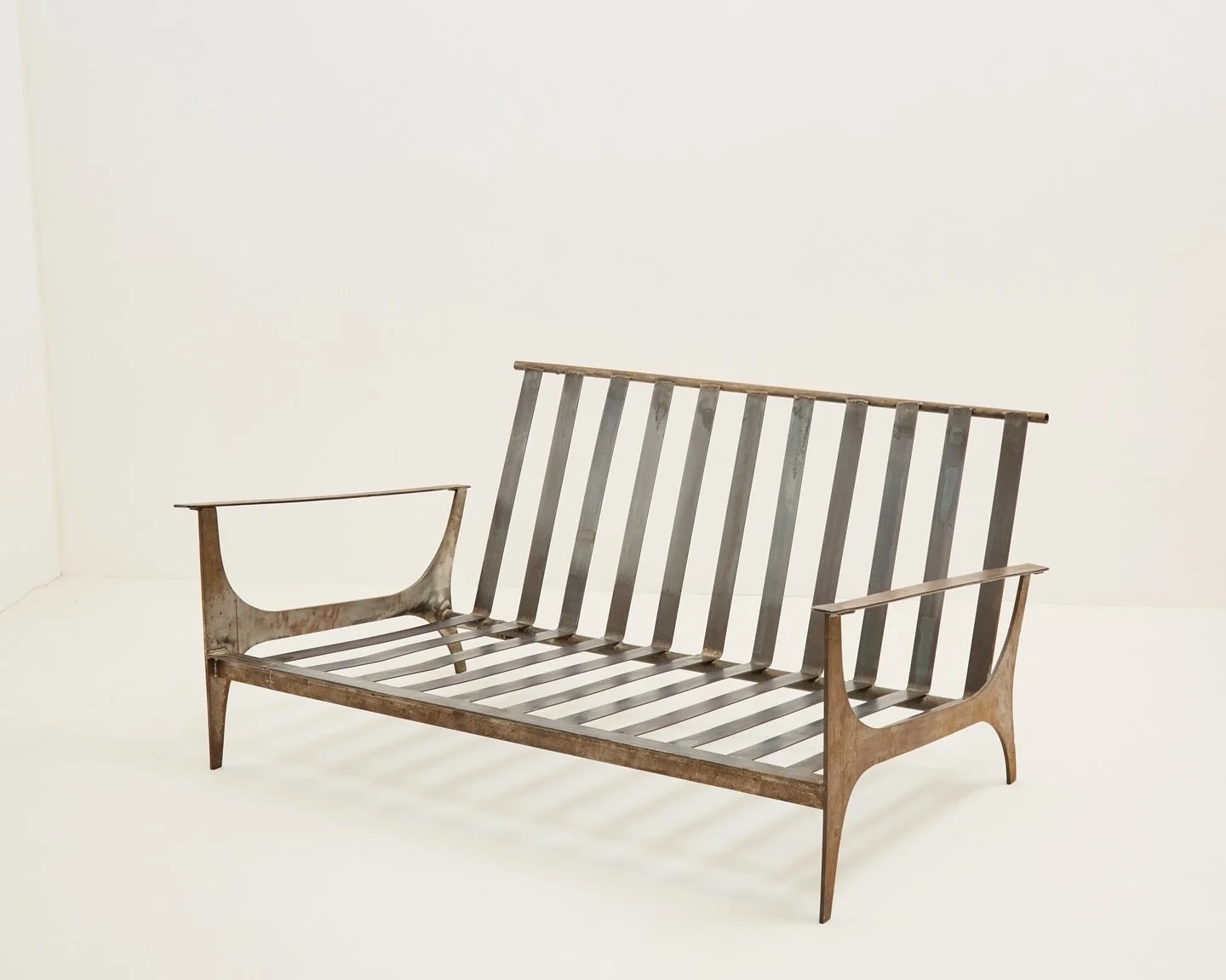 Excellent early 1990s wrought iron and steel strap sofa. Reminiscent of experimental works by Tom Dixon or Ron Arad. 

Now sold.