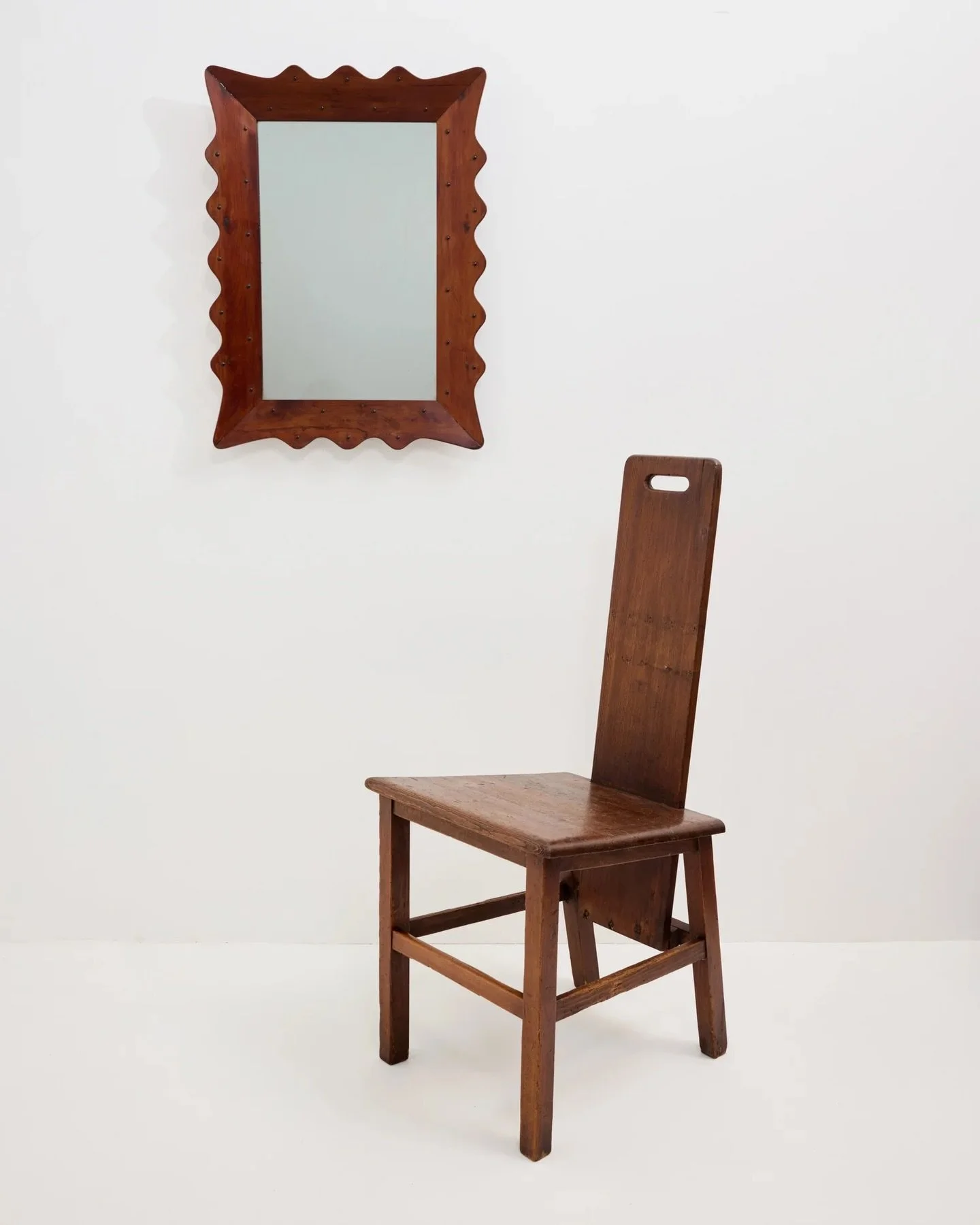 Outlandish high back chair in combed pitch pine. 

Wavy mirror now sold.